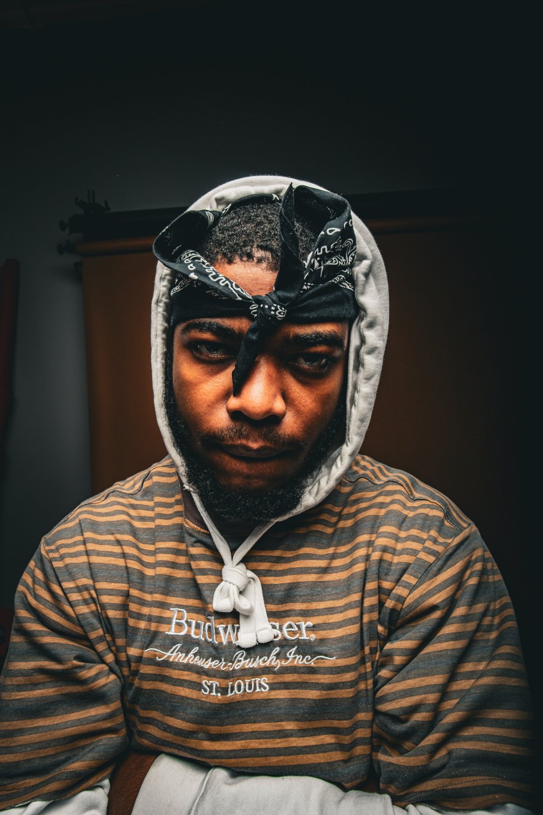 Studio portrait of a man in a hood and black bandana
